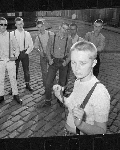 Black and white image of a group of skinheads standing in the street.