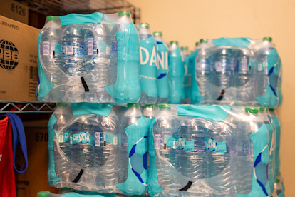 Cases of bottled water stacked on a storage shelf