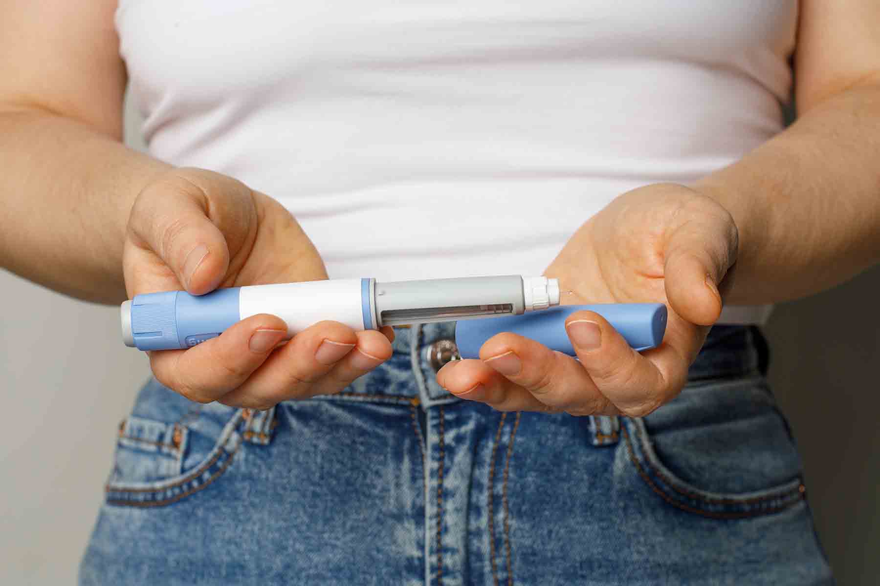 a person inserting a GLP-1 medication