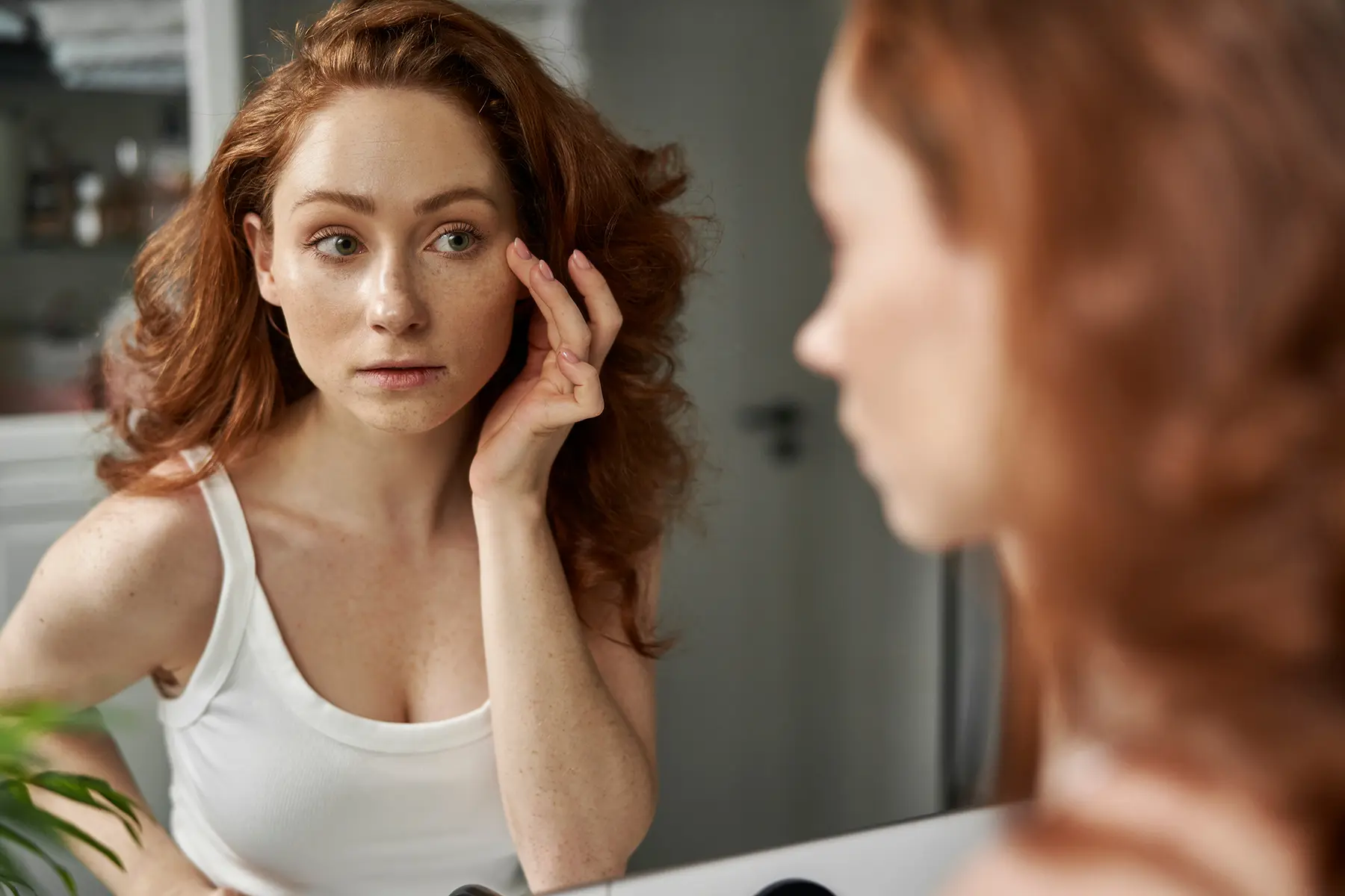 A woman checking her eyelashes