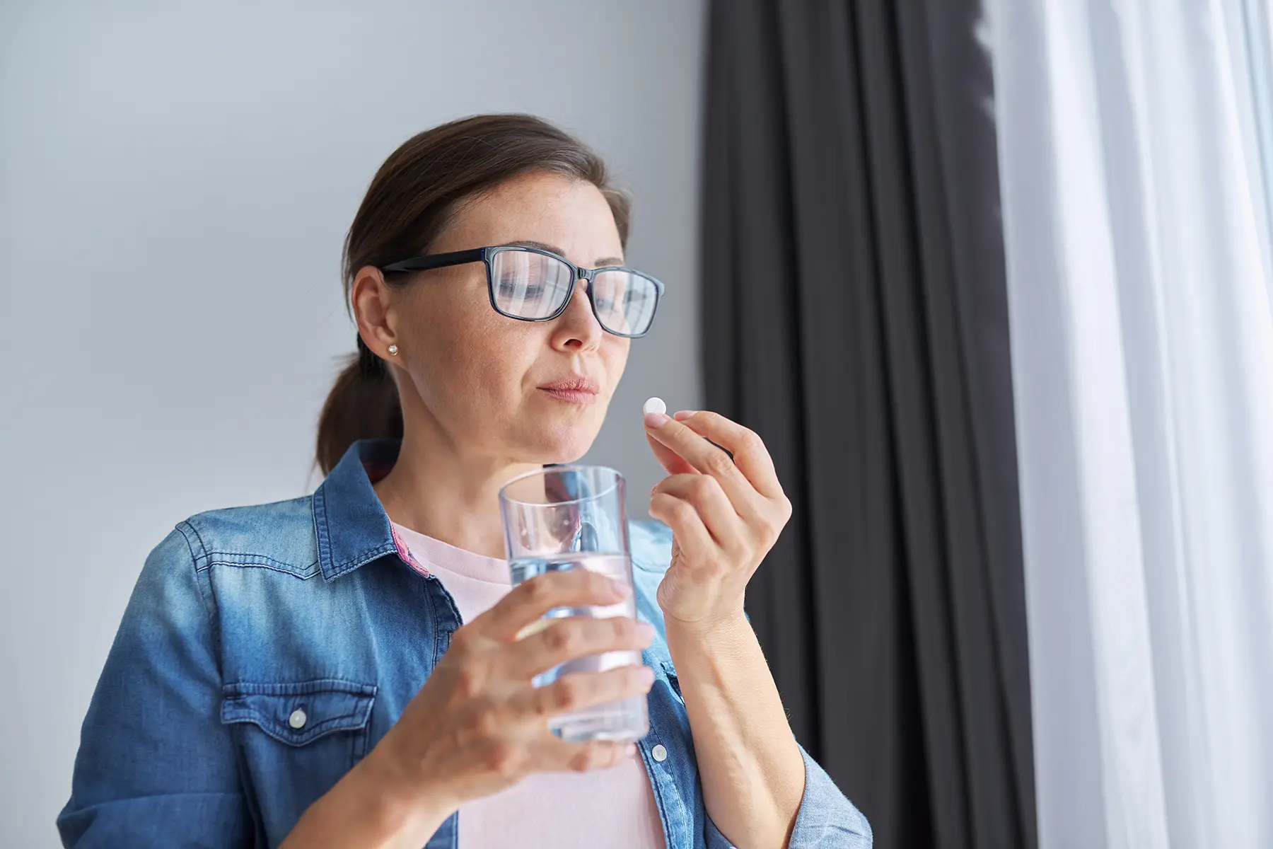 A woman drinking medicine