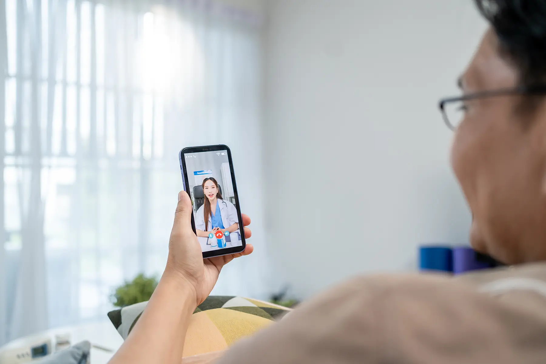 Man using his phone for telehealth call.