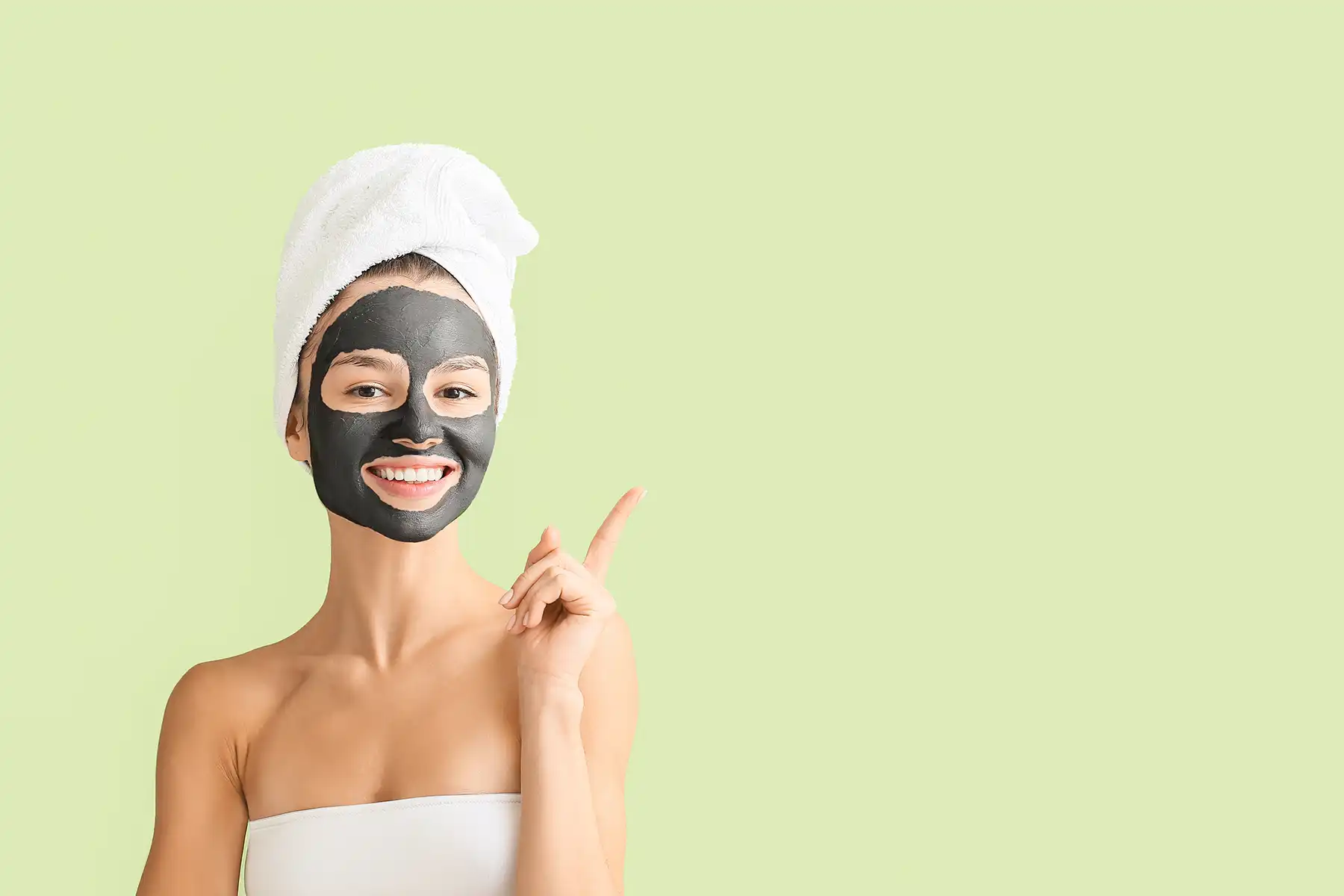 Girl fresh out of the shower with an activated charcoal face mask on