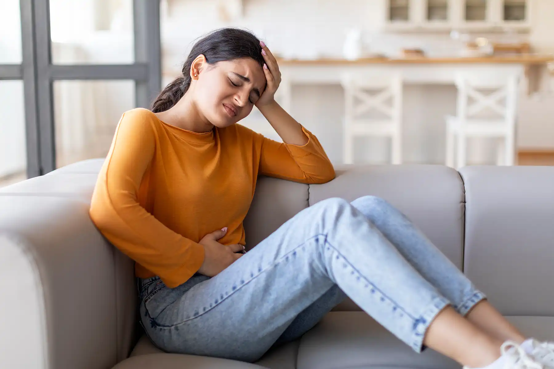 A person holding their stomach in pain