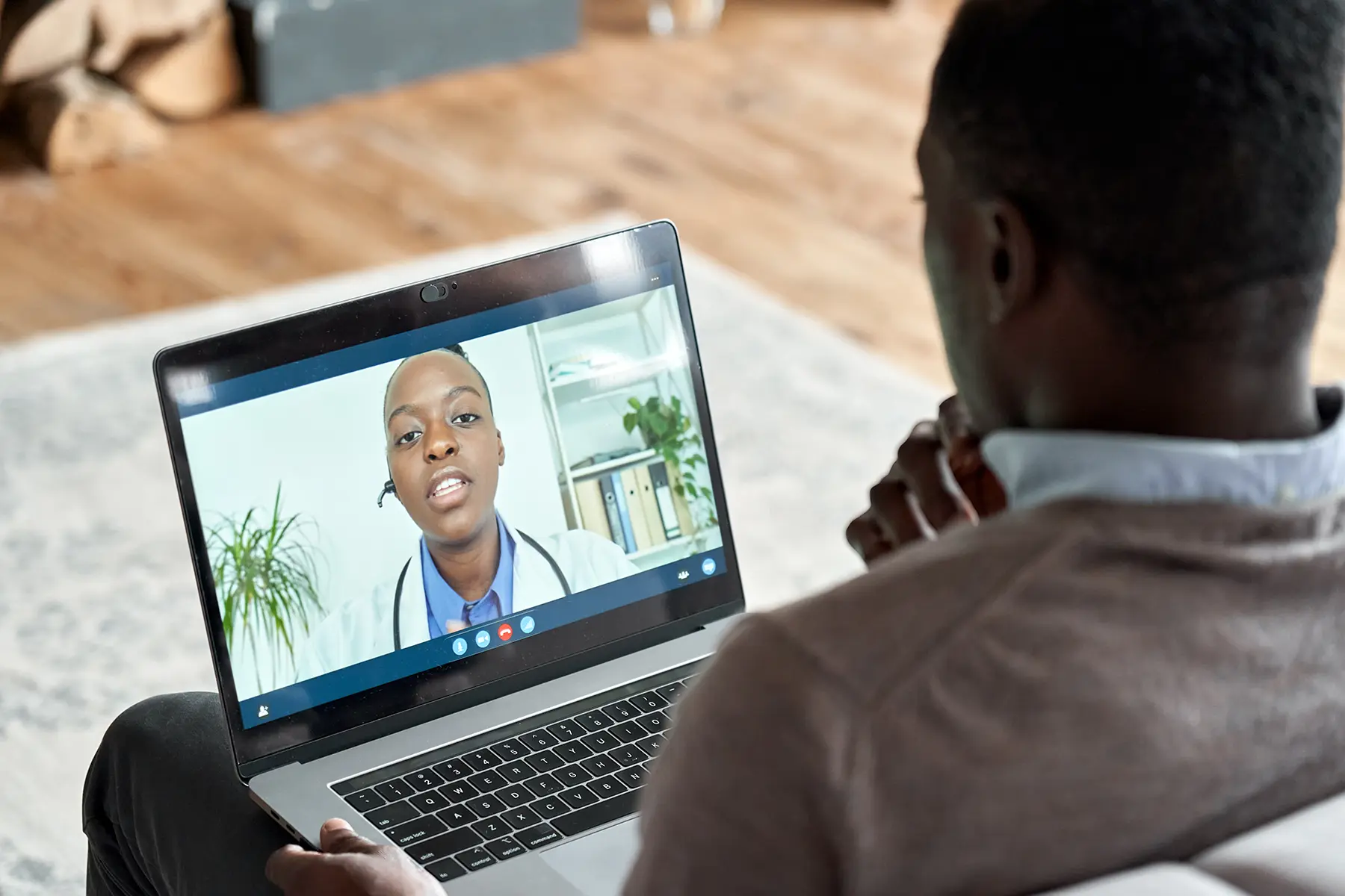 Man on telehealth virtual visit with a doctor from his computer.