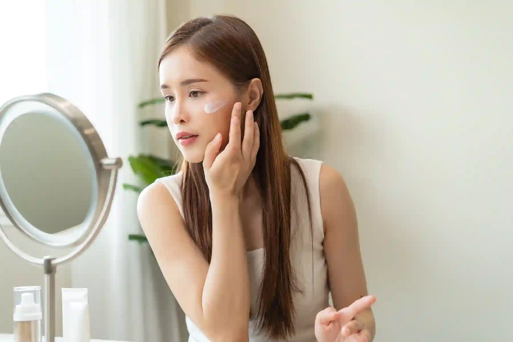 A woman moisturizing her face