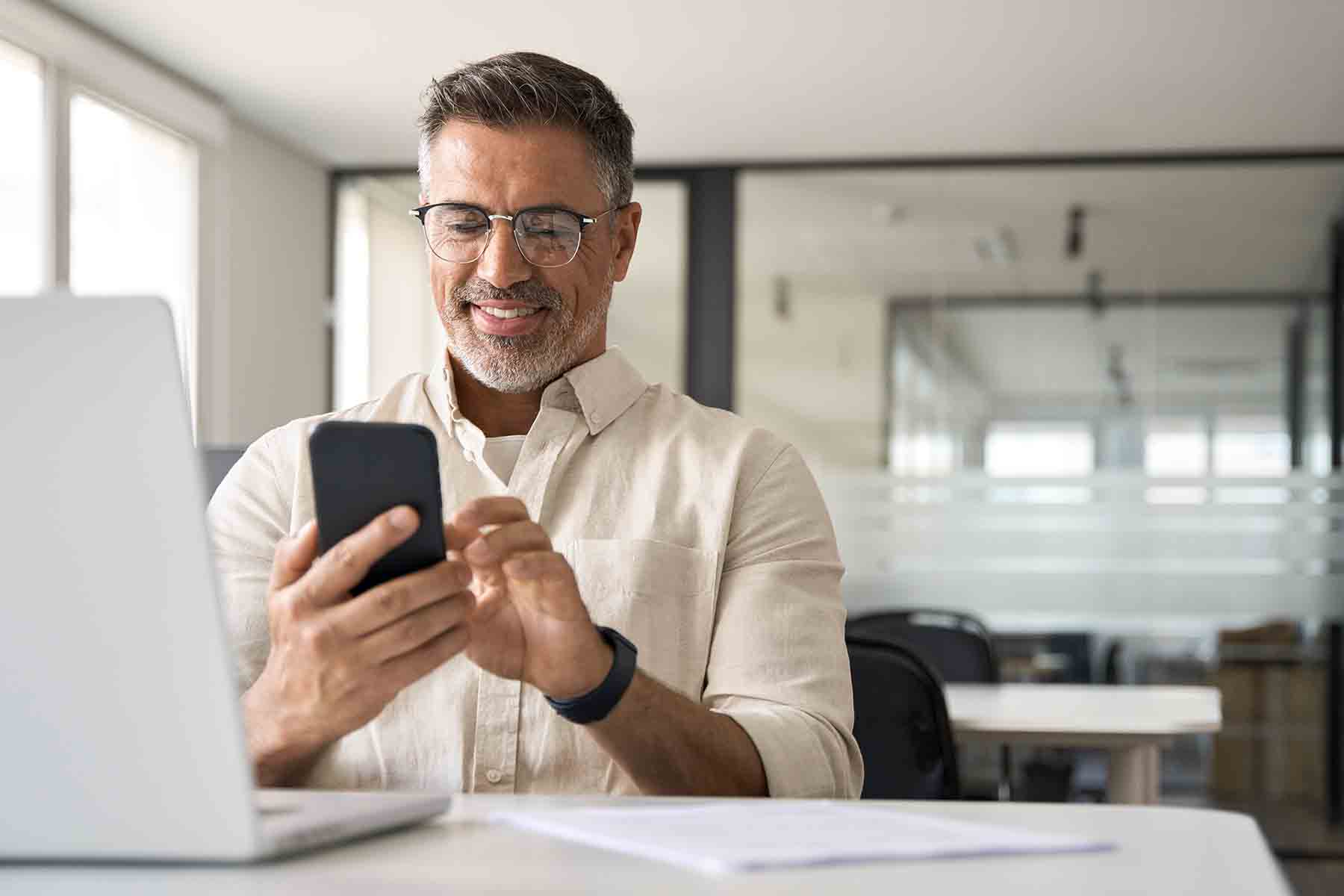 a person on a laptop and his phone