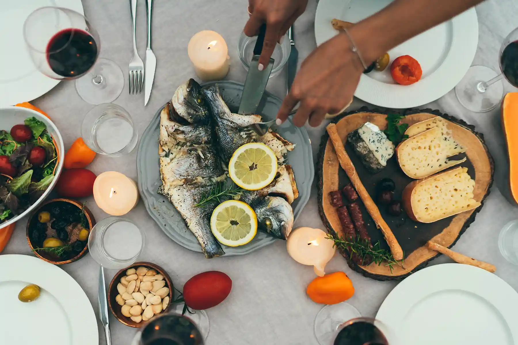 A woman serving fish on the table