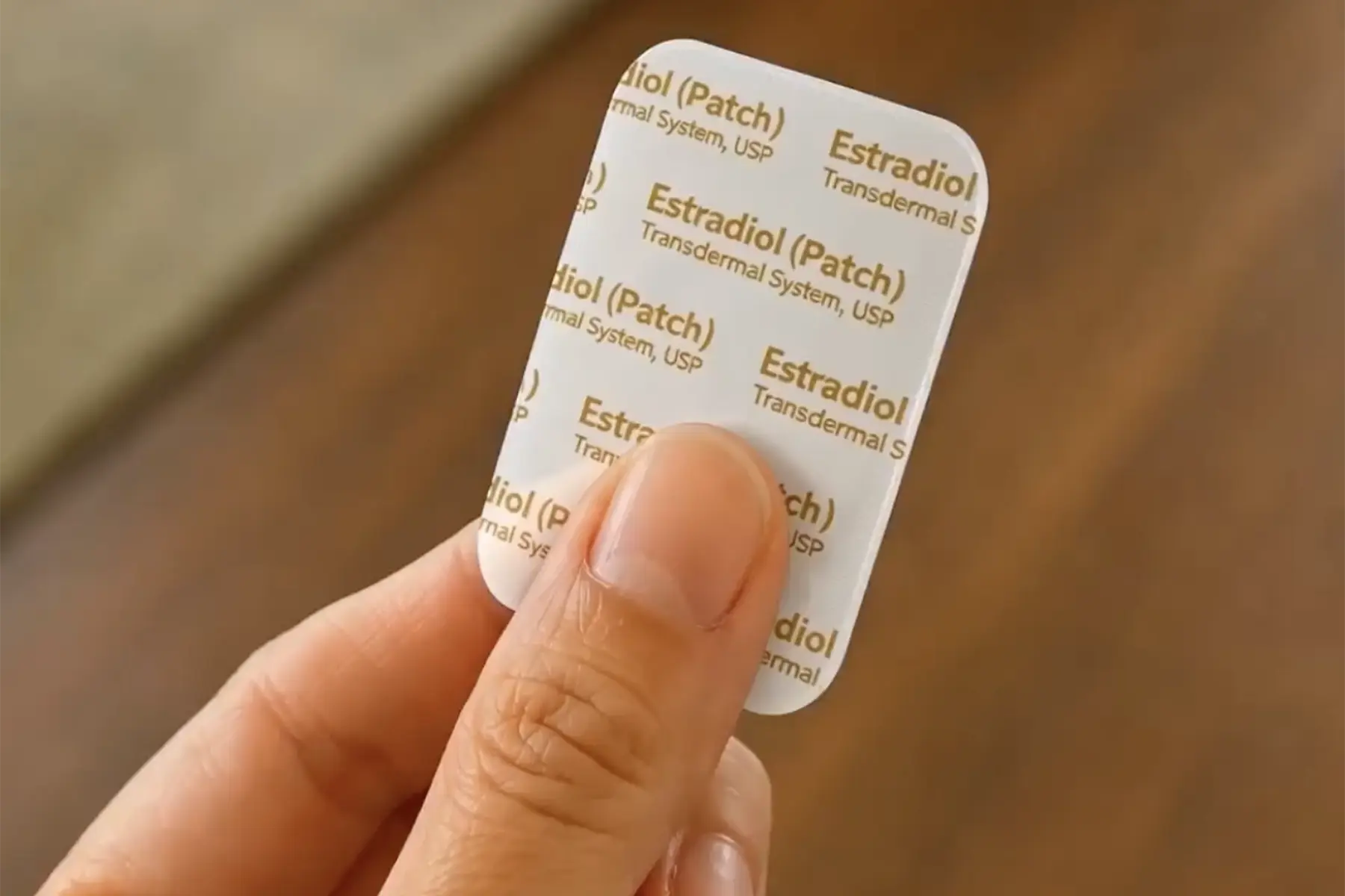 Woman holding the estrogen patch