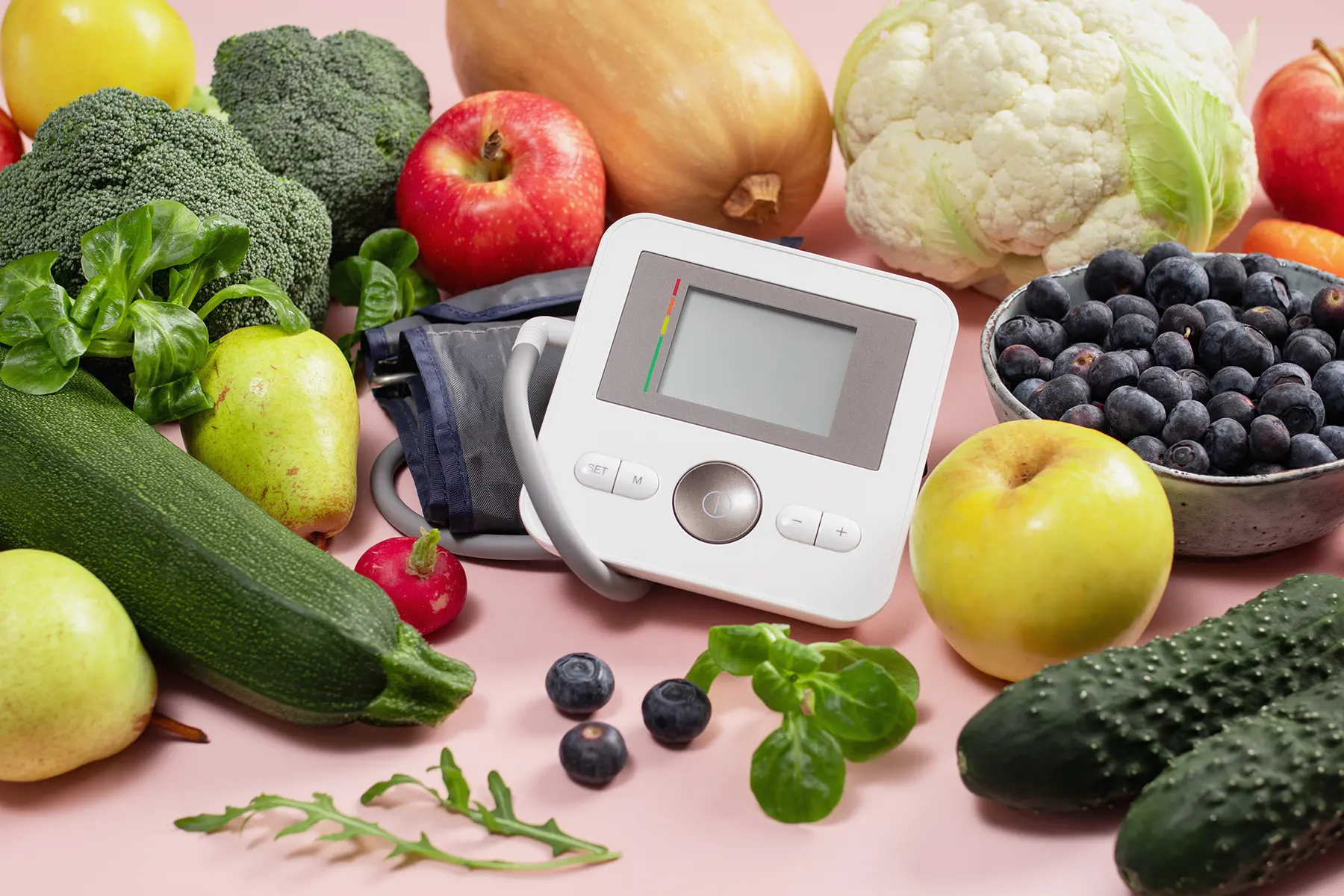 Blood pressure monitor surrounded by foods in the DASH diet