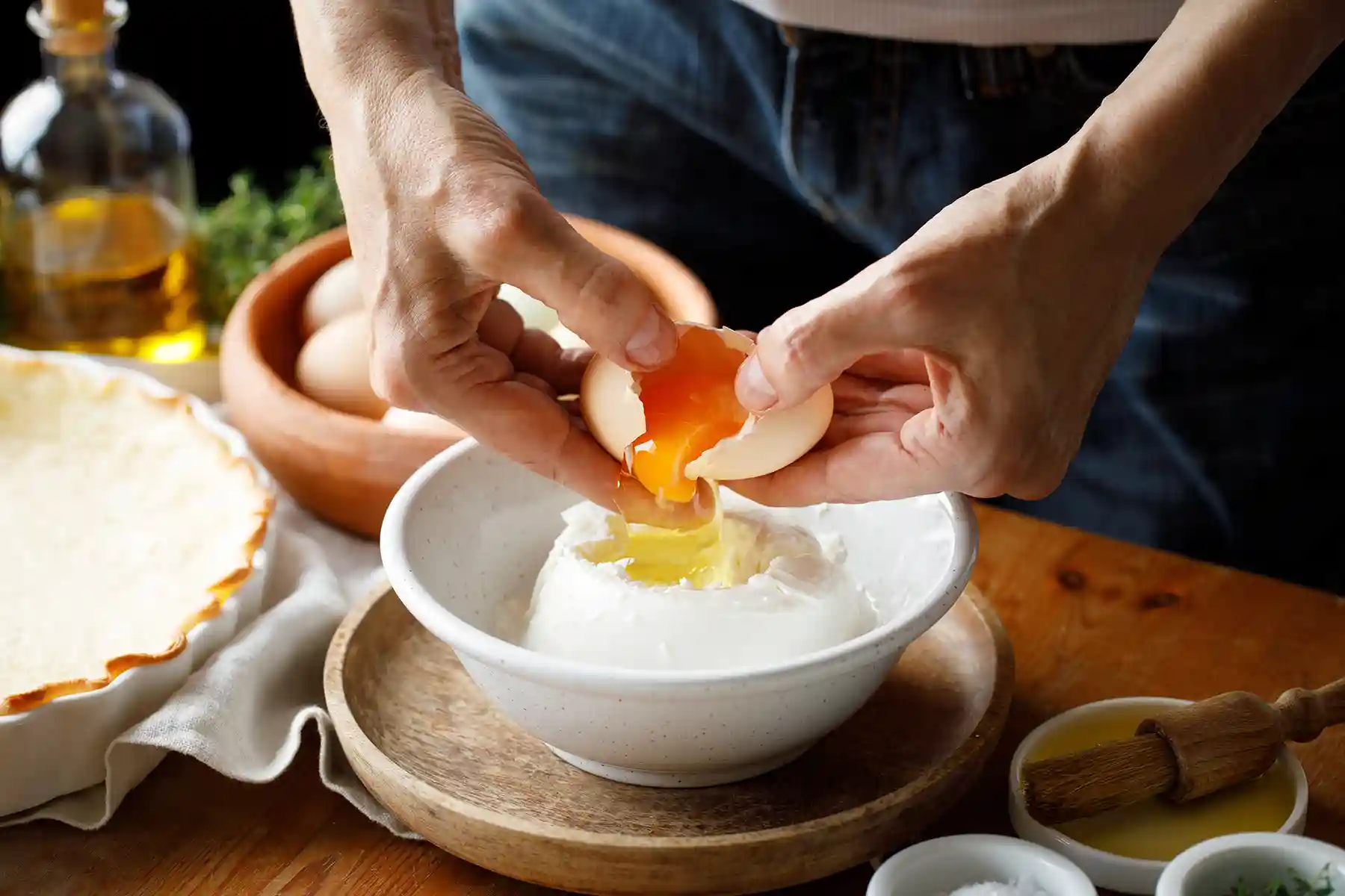 A man separating the yolk from the egg white.