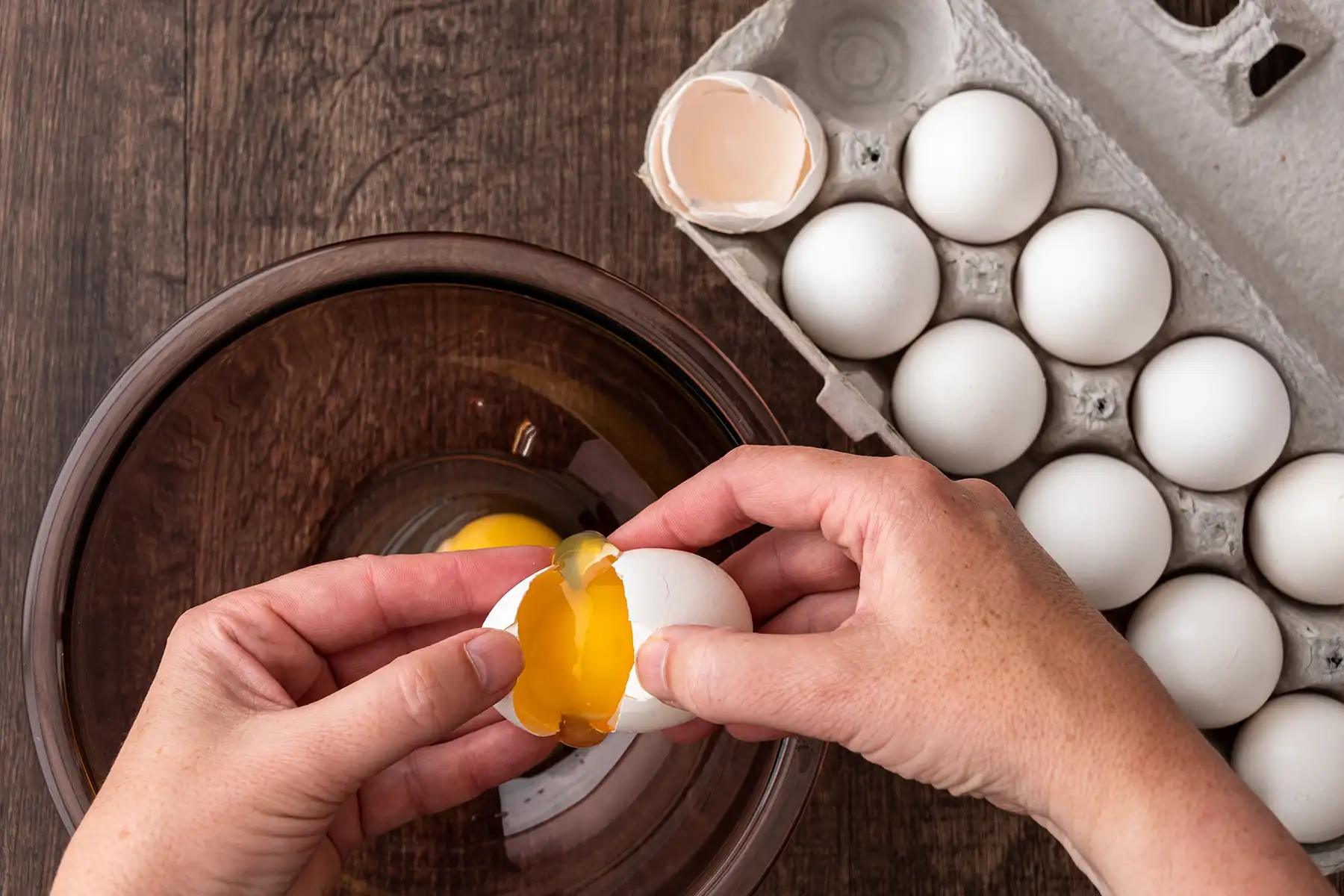 A man separating egg yoke from the white