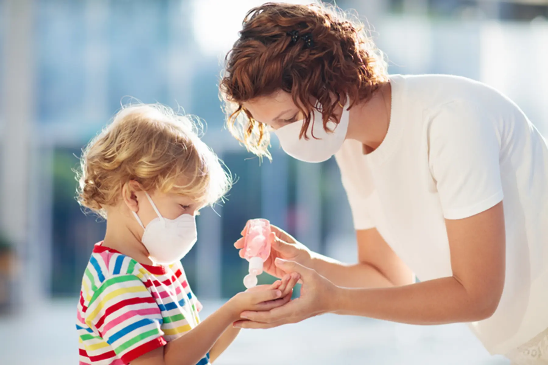 Mother and son using a hand sanitizer