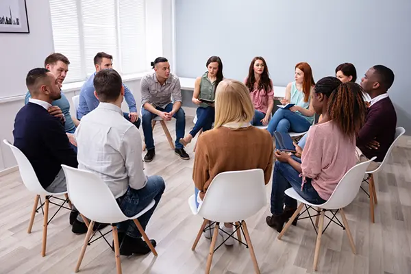 Group therapy session with patients sitting in a circle.