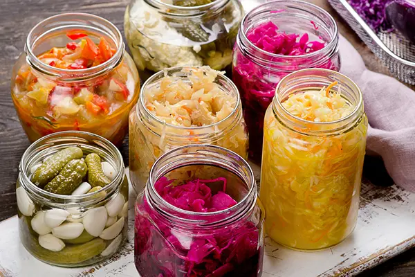 Several jars of fermented, probiotic-rich foods.