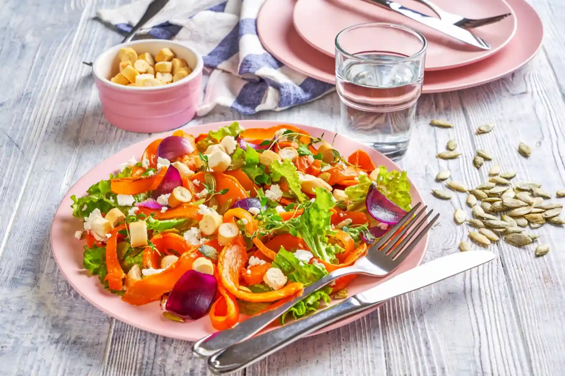 A healthy salad and a glass of water.