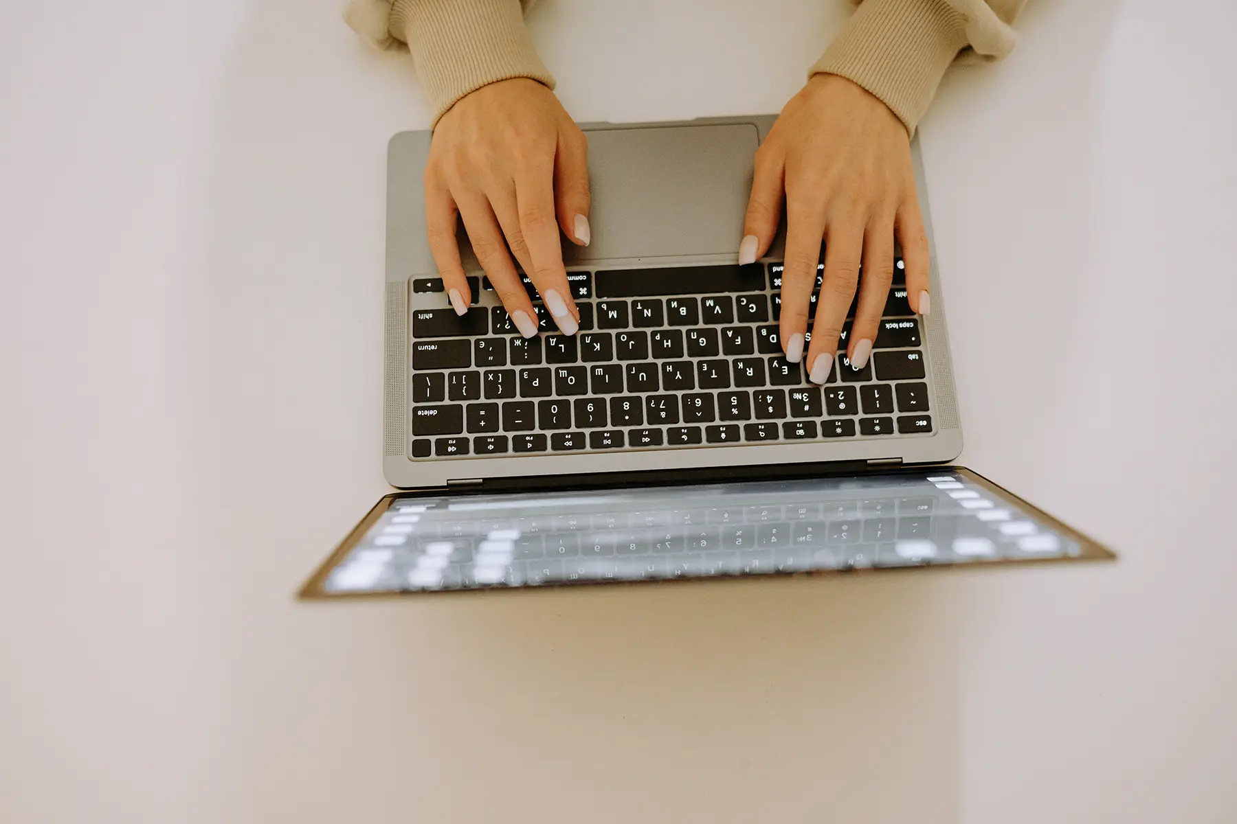 Overhead shot of woman typing on laptop