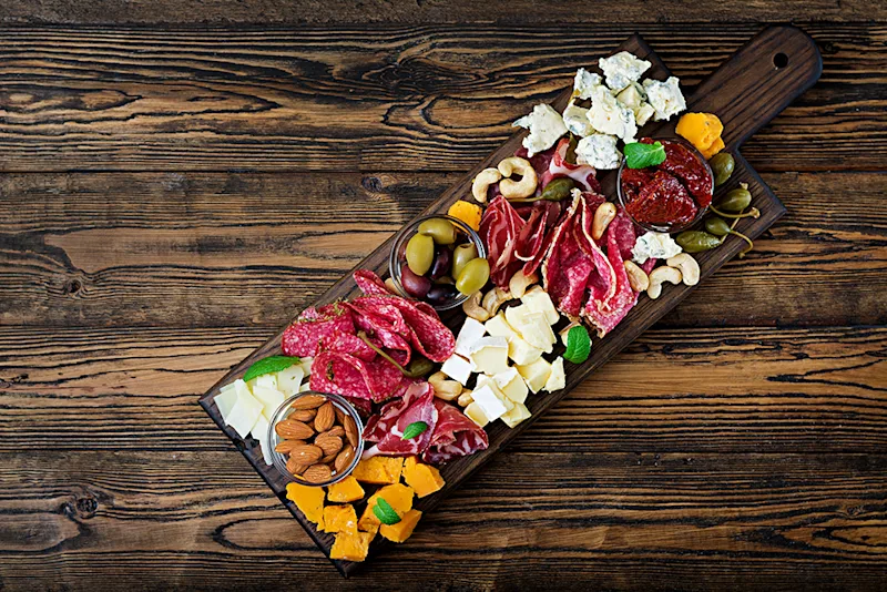 Antipasti board with cured meats and olives