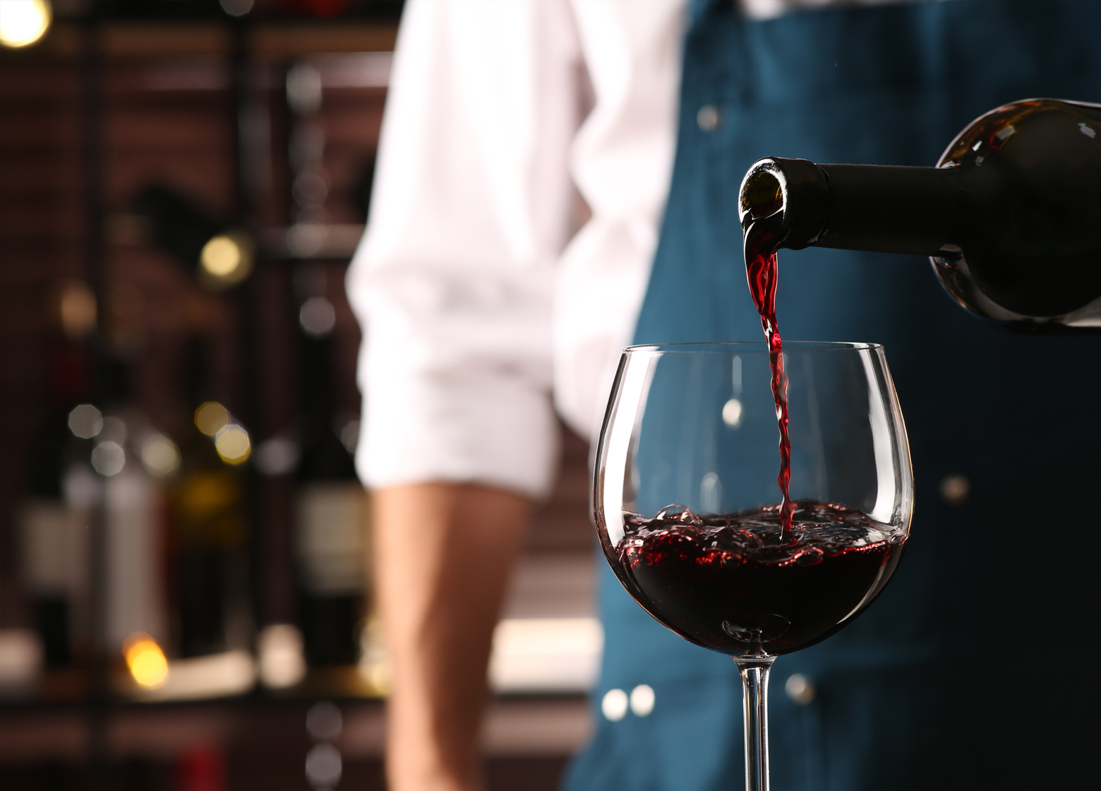 image of red wine being poured into a glass