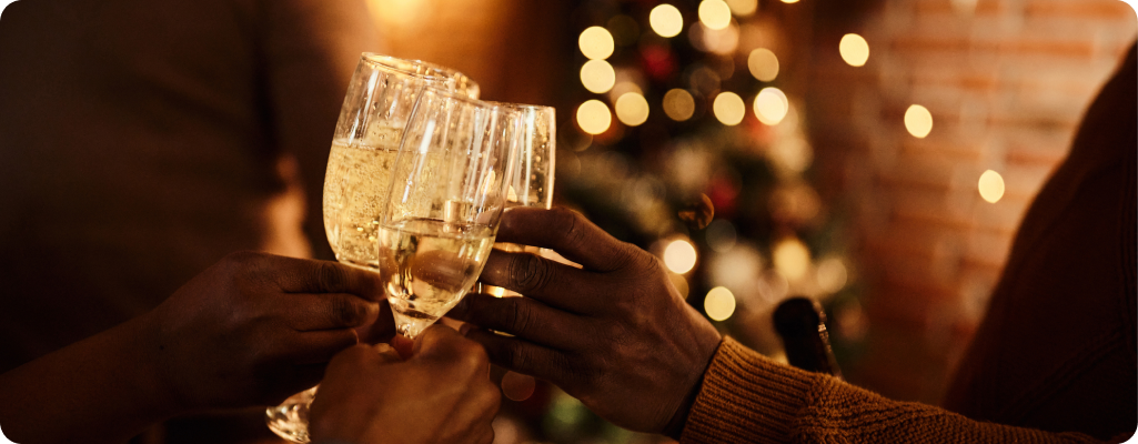 image of three people clinking full glasses of champagne