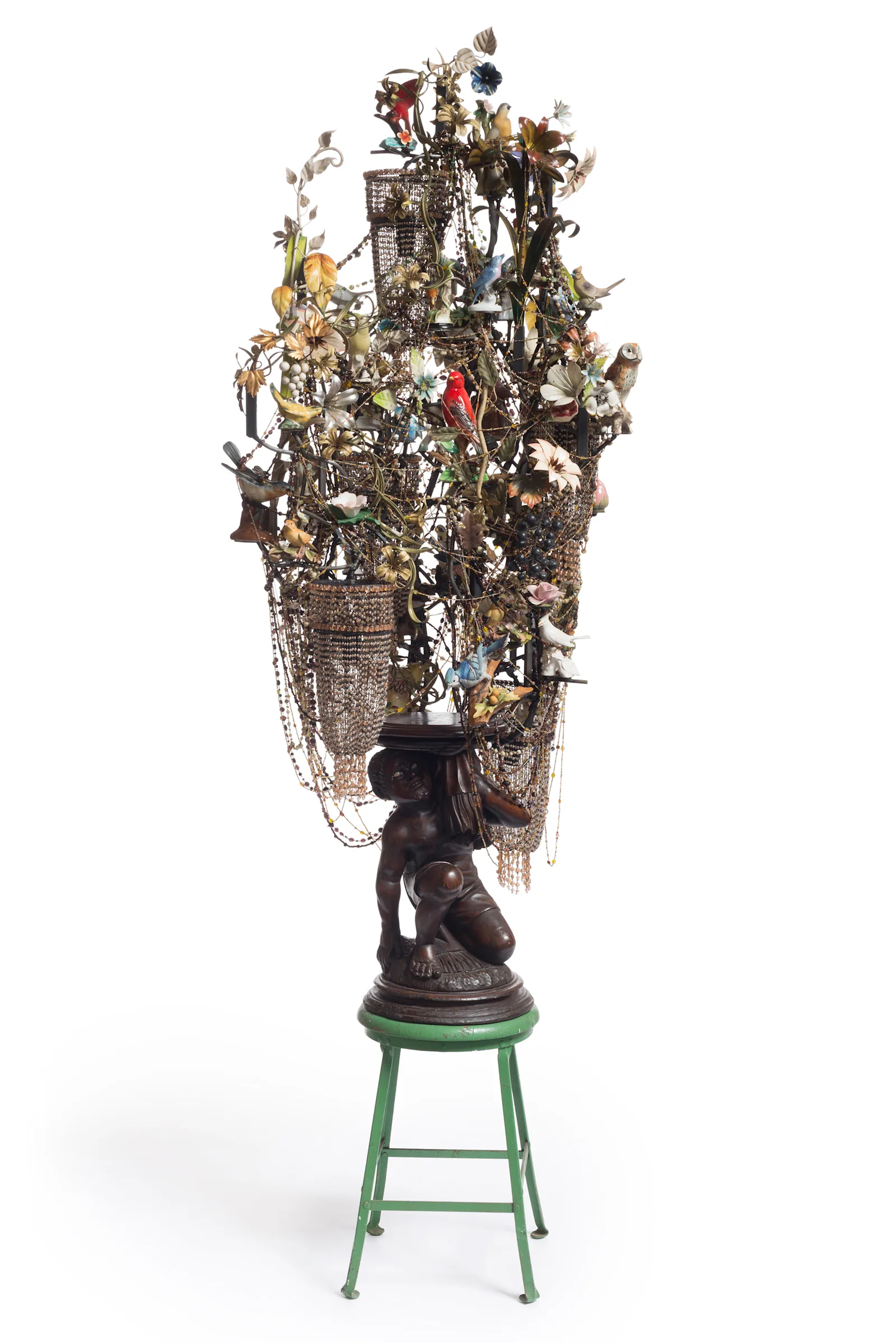 *End Upheld*, 2014, mixed media including carved stool, light fixtures, ceramic birds, metal flowers and strung beads.