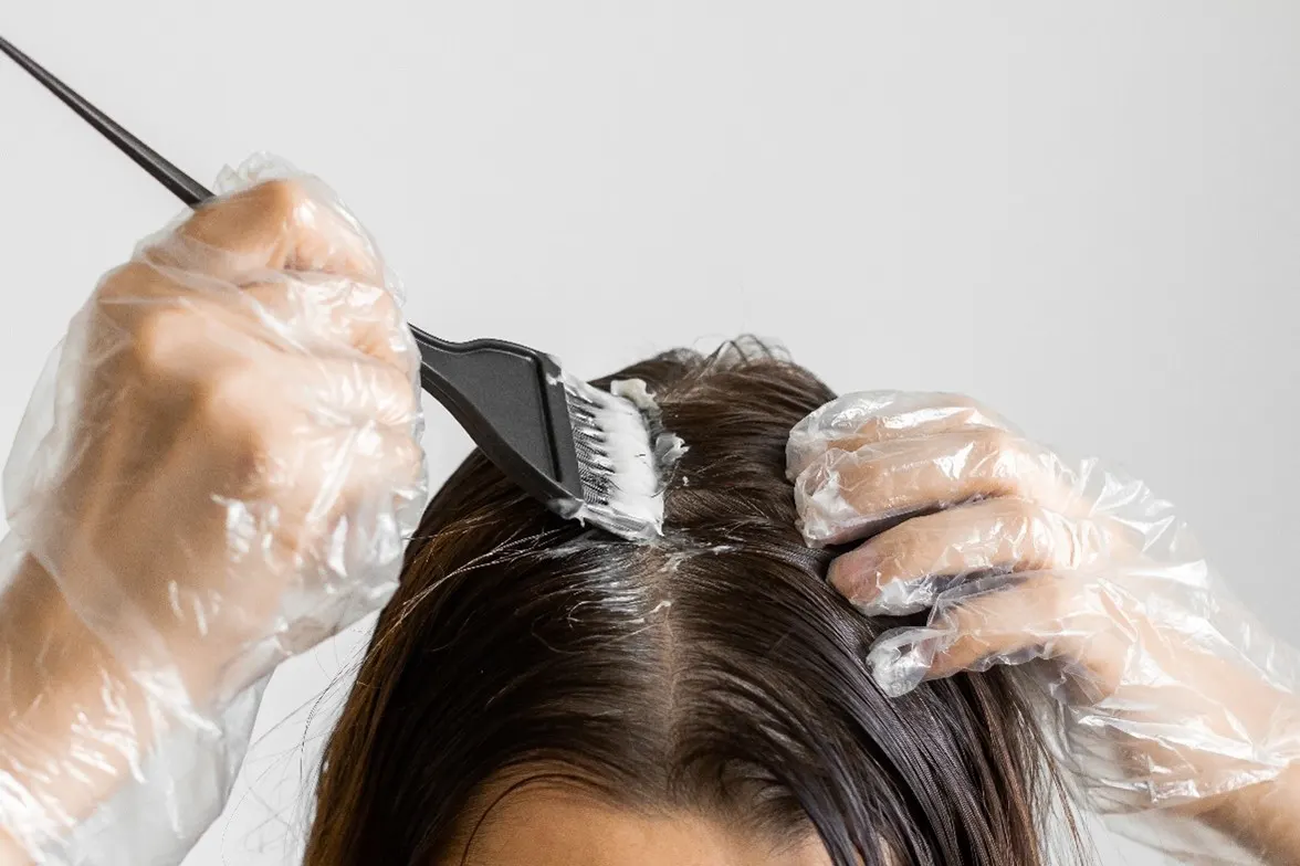 Woman applying hair dye