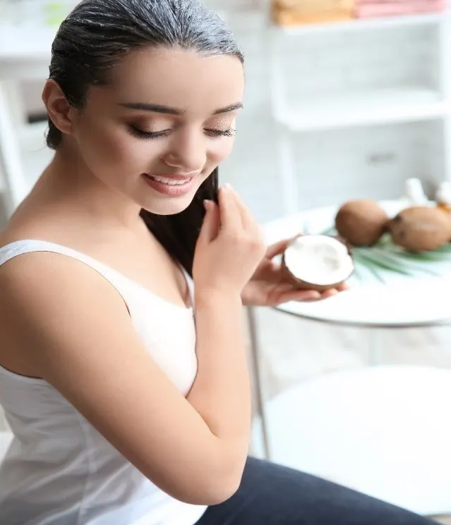 Girl applying coconut oil