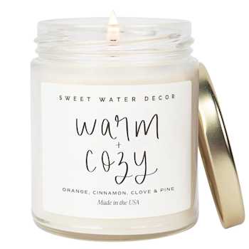 A white candle scented "warm and cozy"