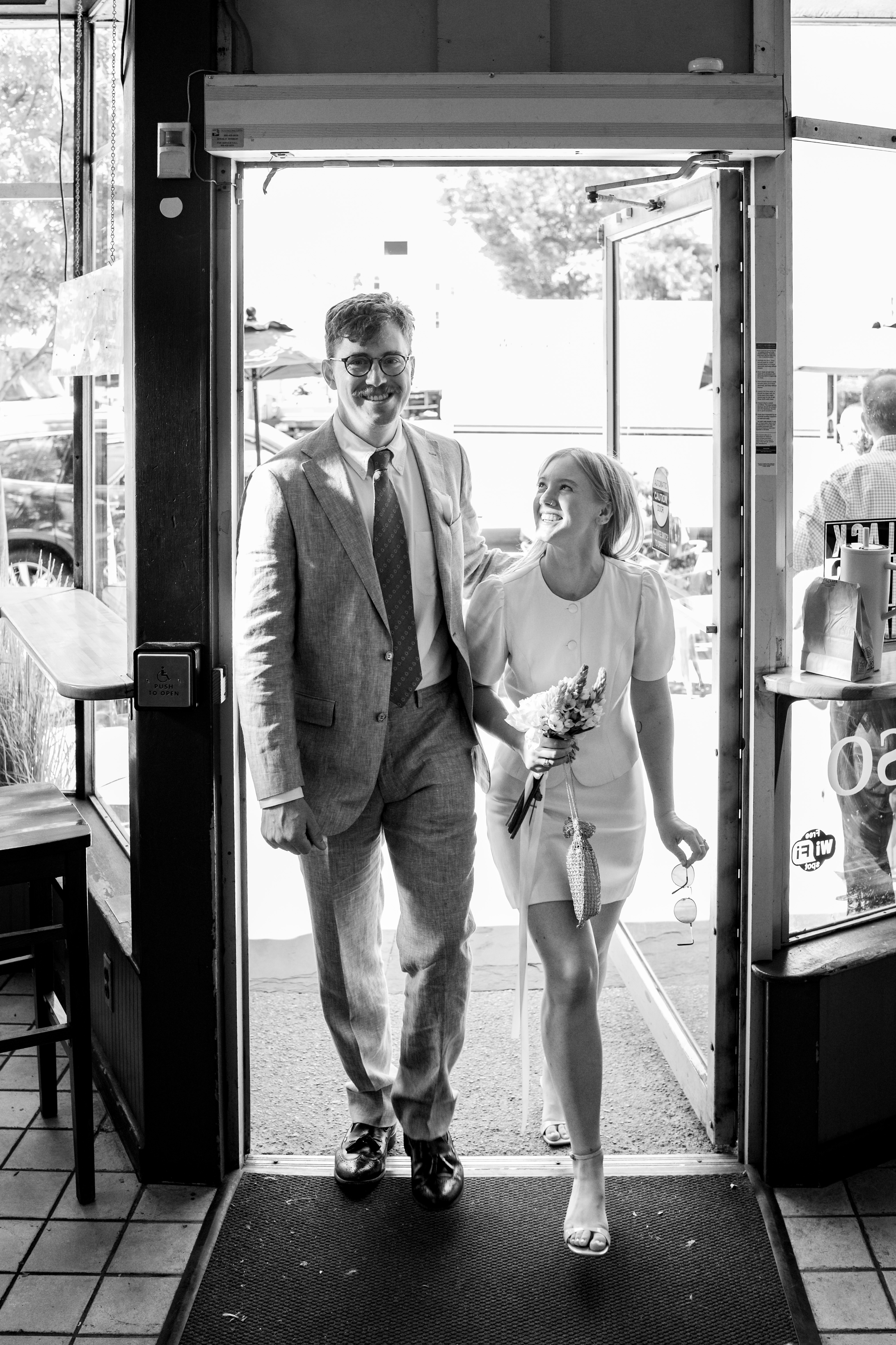 Wedding Couple Entering Cafe BW