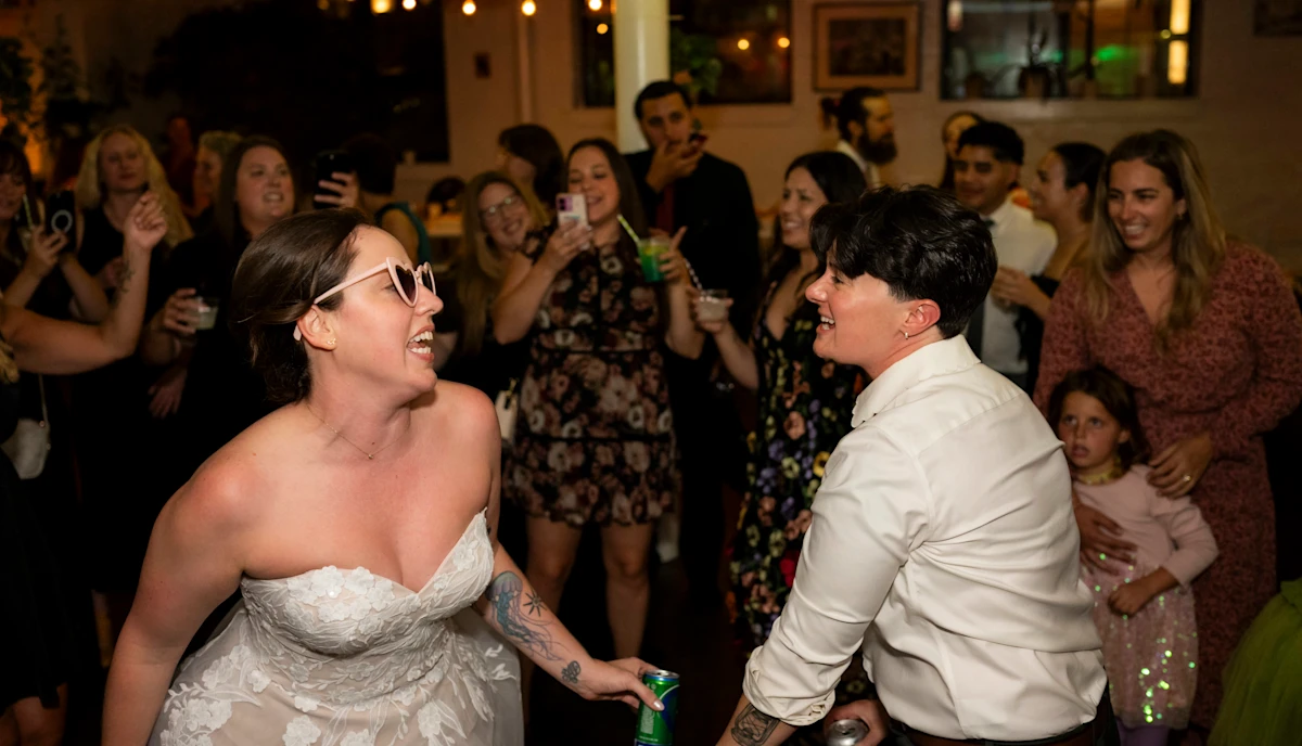 Brides dancing inside circle at White Room