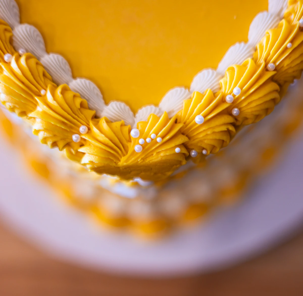 Yellow cake closeup of icing and decoration.