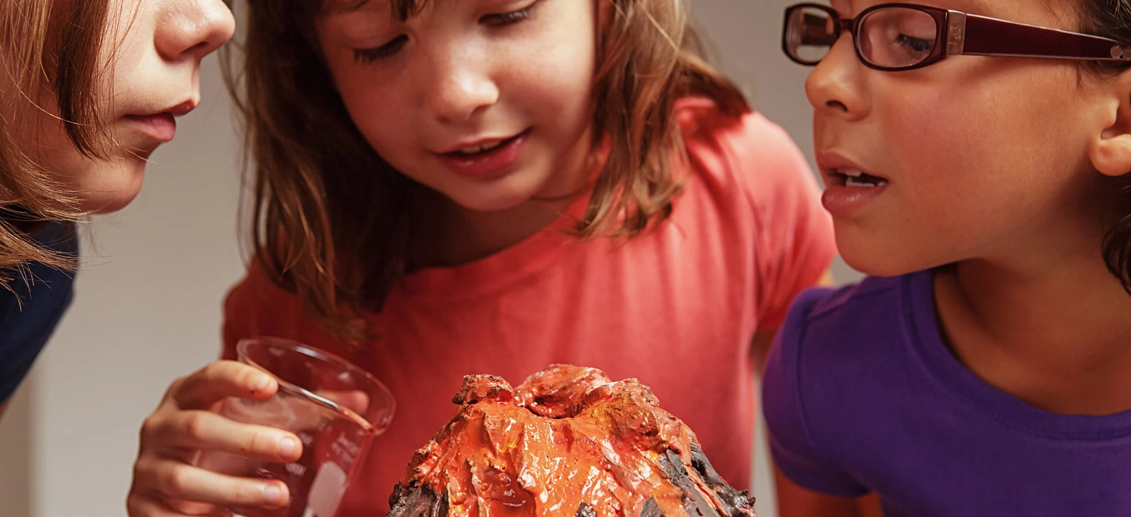 Three Girls watching the paper volcano