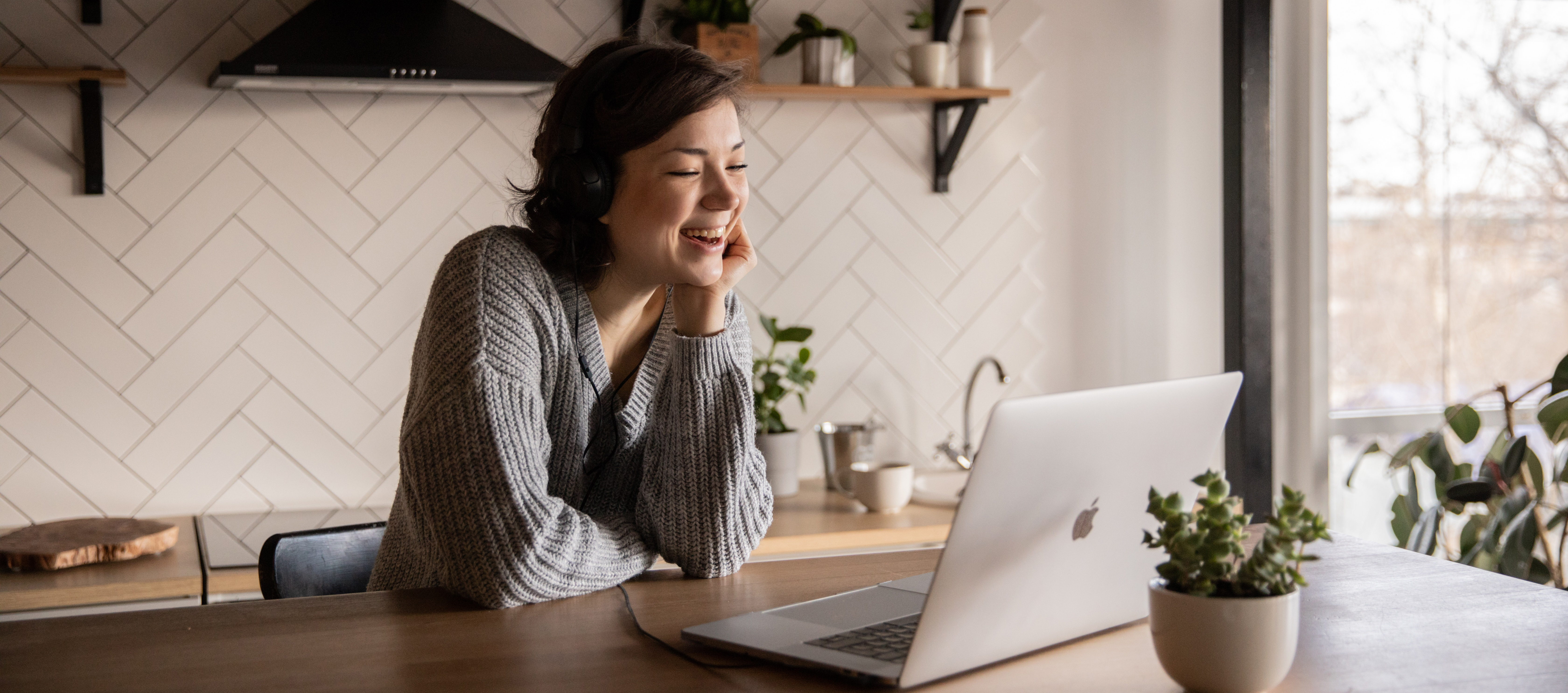 Young woman smiling at laptop
