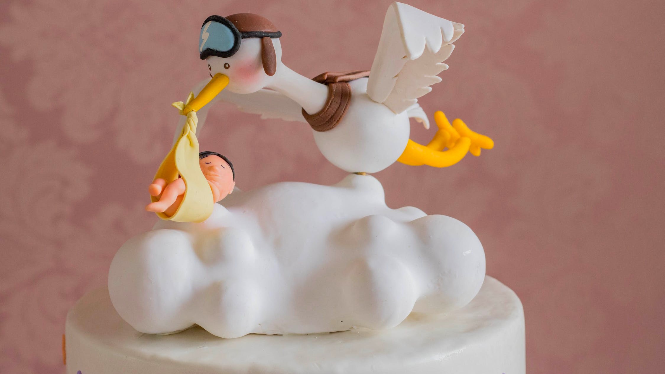 A cake with bird carrying a child over the clouds