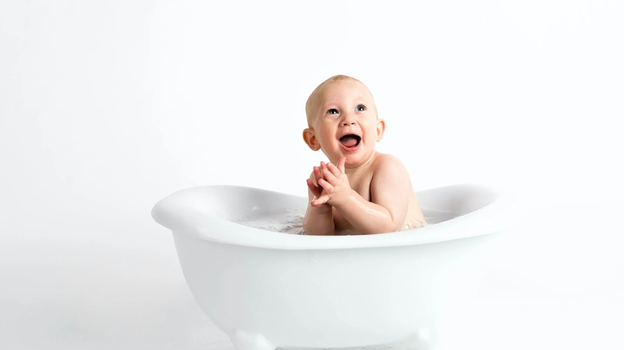 Baby smiling and taking a bath