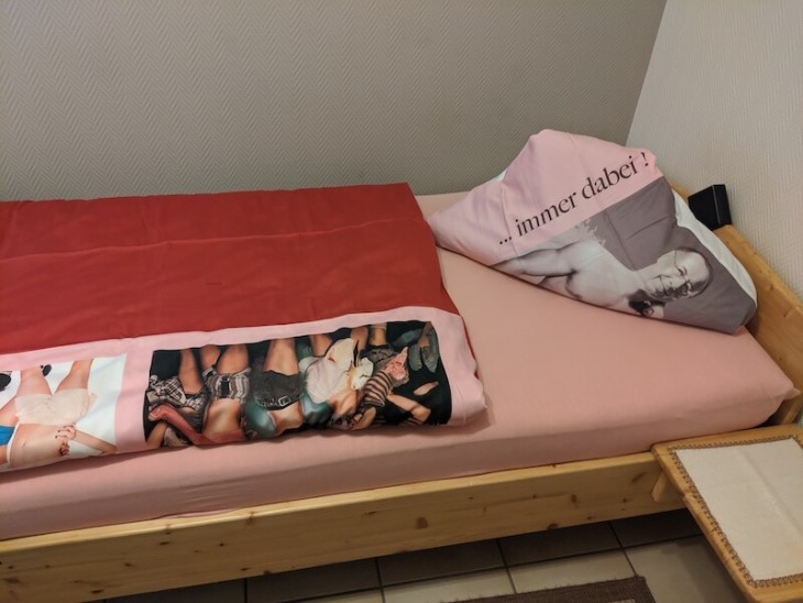 The most awkward bedding ever seen in a hotel. Pink sheets with a topless image of the hotel owner and a duvet with some pop girl group on.