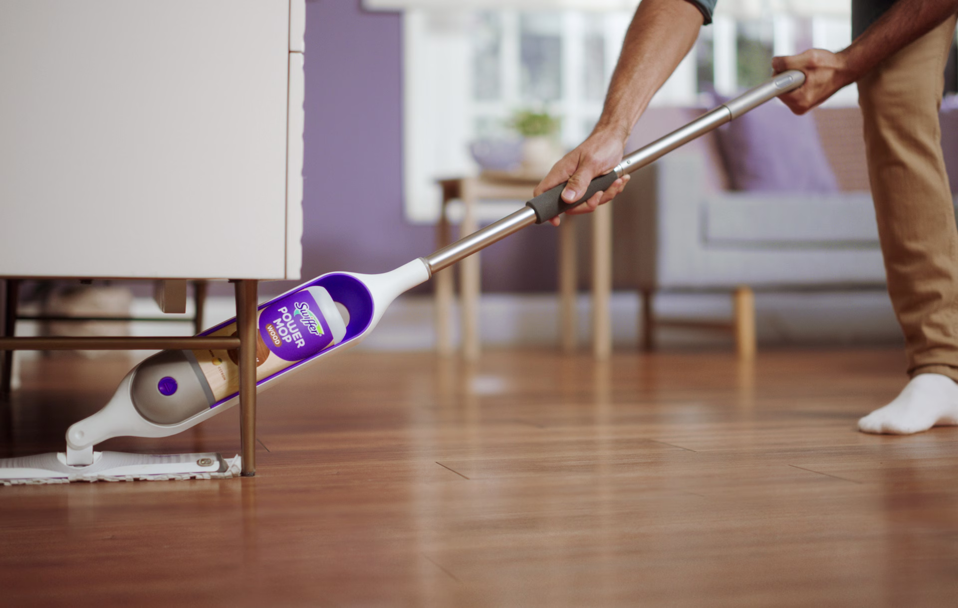 Cleaning with PowerMop wooden floor under the chair