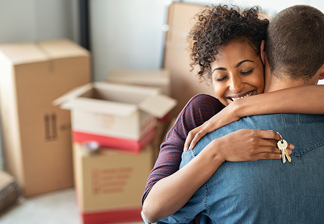 couple hugging in new home after mortgage referral