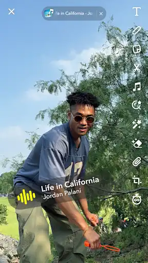Creator posing with music track waveform overlay