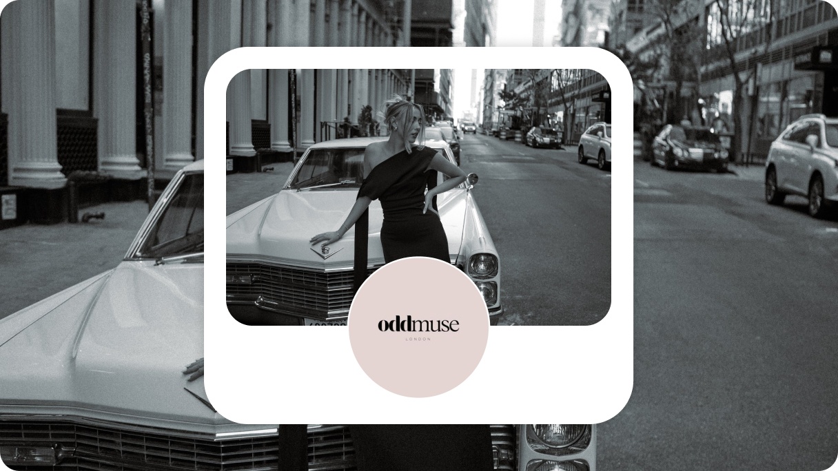 Pinterest profile card for Oddmuse. Circle with the black Oddmuse logo on a pale pink background, in front of a black and white image of a woman wearing a black dress leaning against a classic white car.