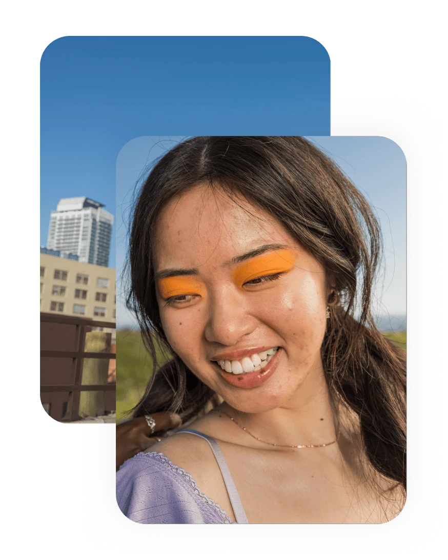 Image of a smiling woman with orange eye makeup
