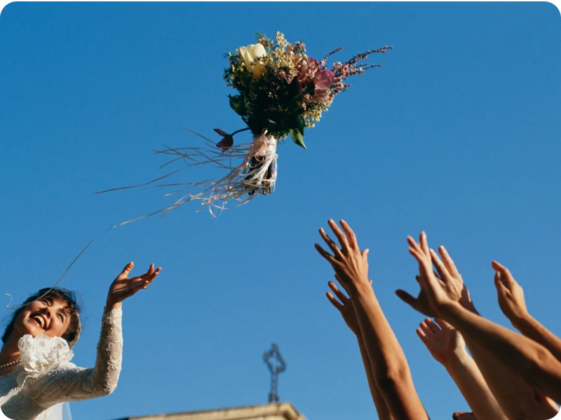 Image of bride throwing bouquet