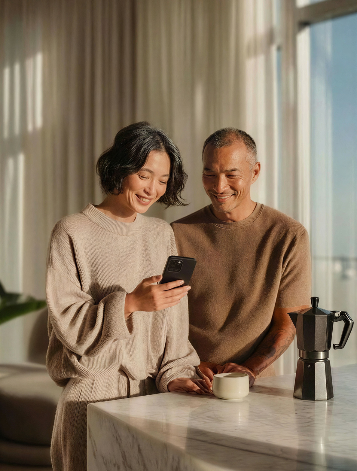 Image of a couple smiling while looking at their phone