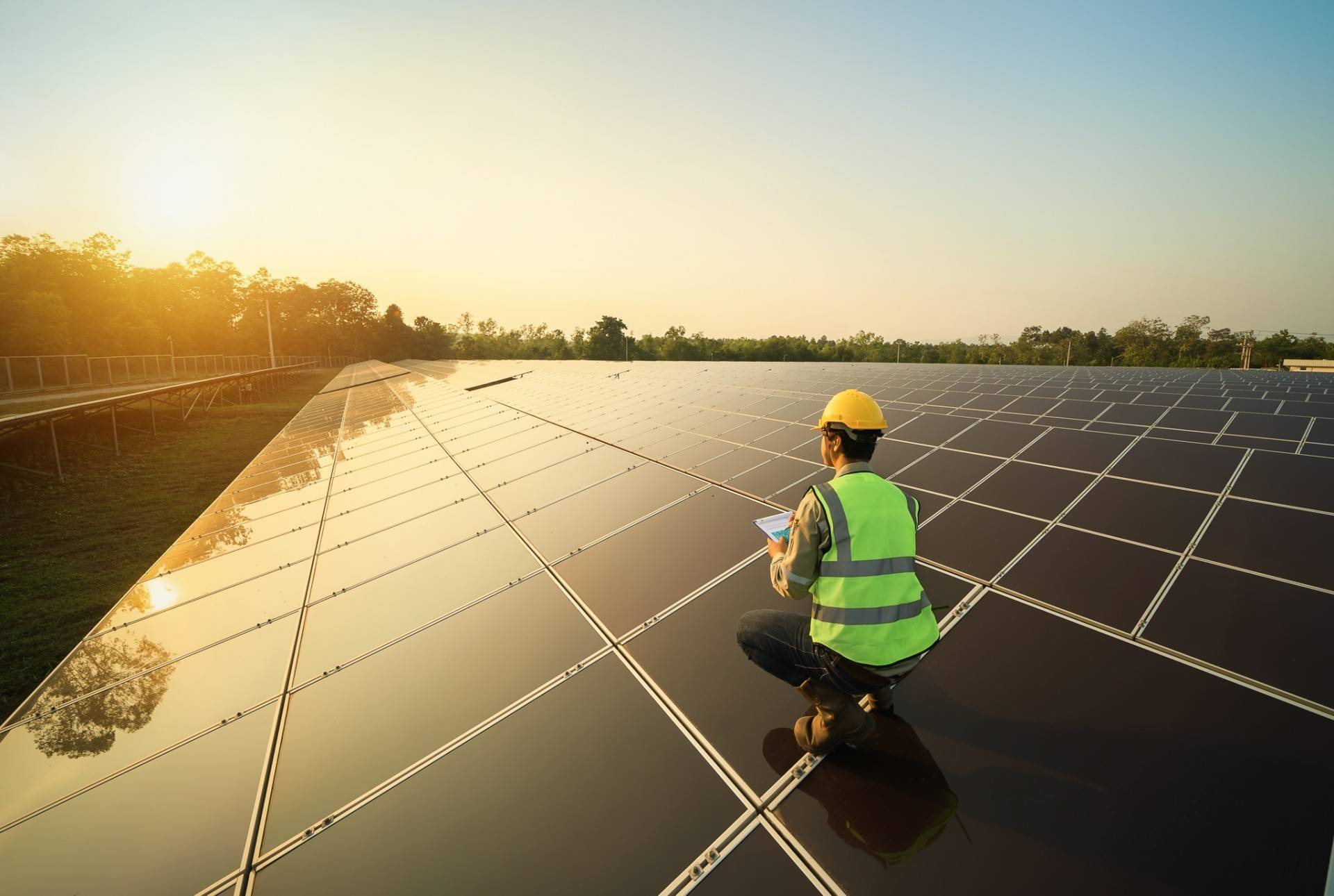 Man crouching on solar panels