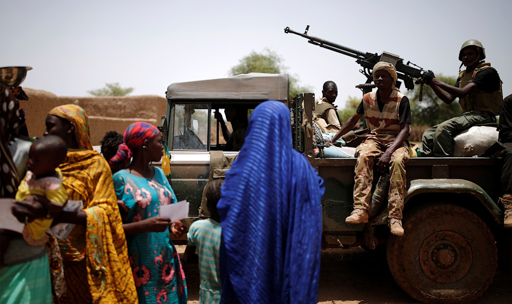 FAMa soldiers in car in front of women in Mali