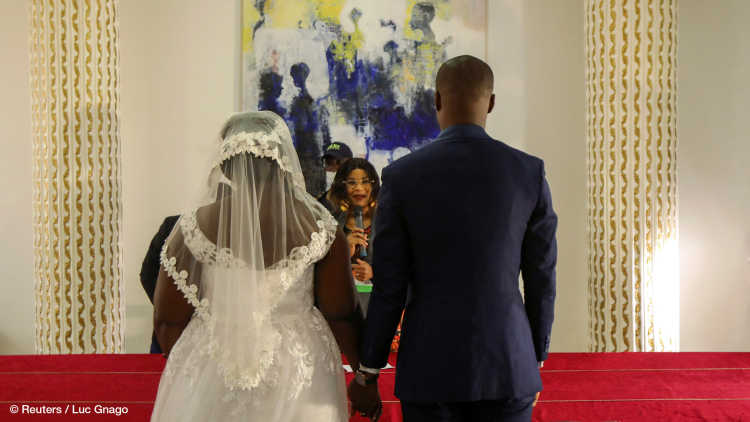 Indat Ange Desire, 30, and Marie Andrea Offoumou, 28, attend their wedding ceremony, following the easing of restrictive measures against the spread of the coronavirus disease (COVID-19), in Abidjan, Ivory Coast May 15, 2020.