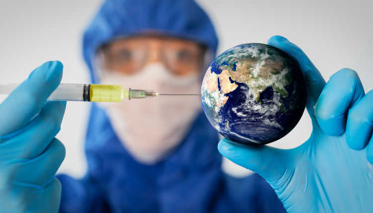 One person in complete protective equipment inoculates a globe in the size of a tennis ball