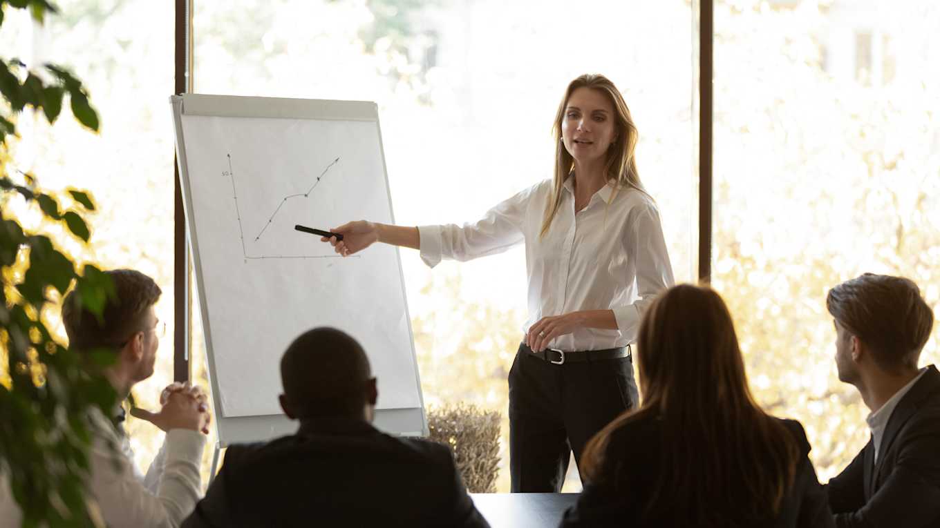 Female speaker give flip chart presentation at conference training meeting