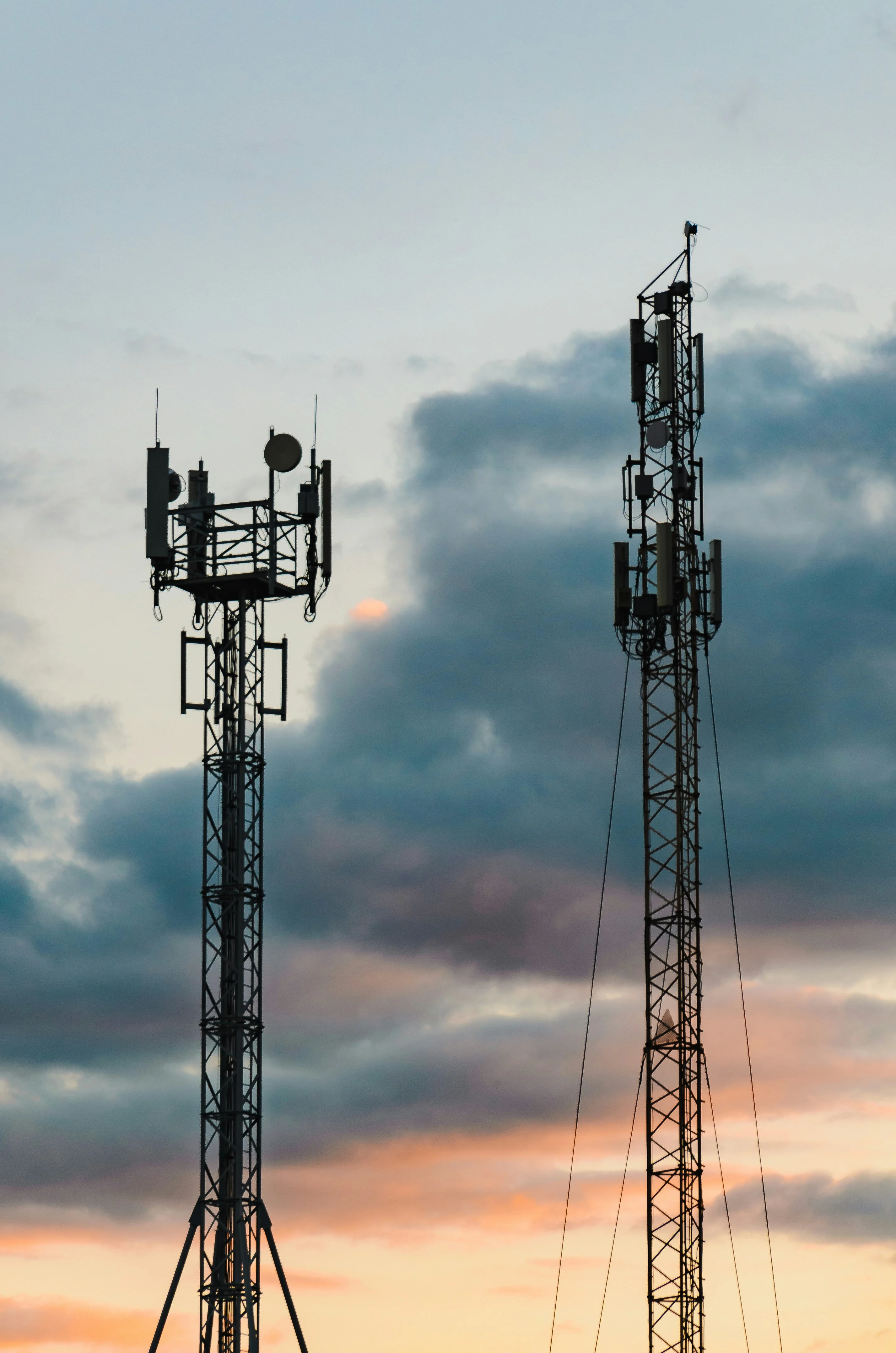 Two telecom towers at sunset