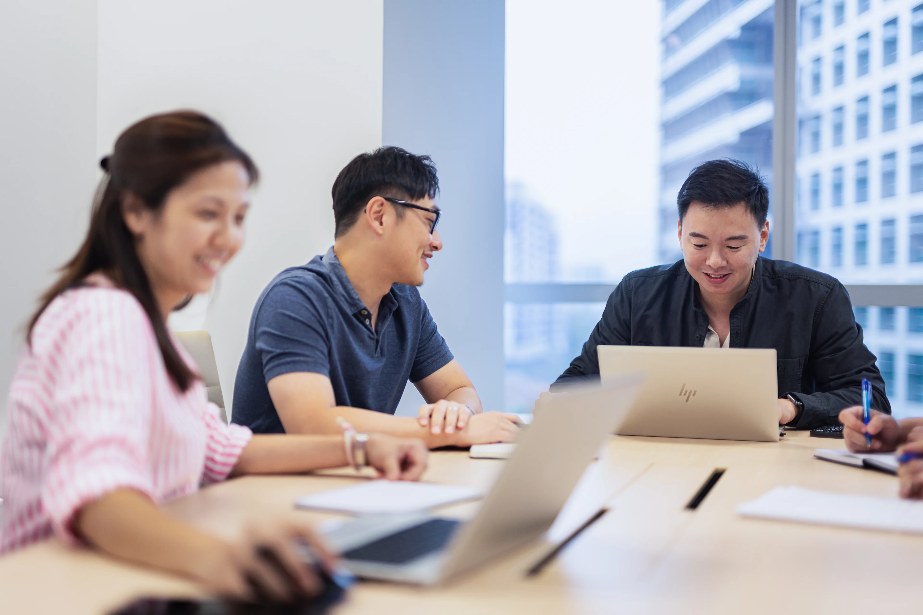 Group of Fusion Worldwide APAC employees conducting a meeting in a conference room